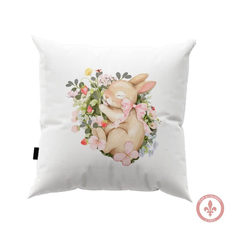 housse de coussin blanc avec motif imprimé un petit lapin qui fait la sieste entouré de fraises et de fleurs